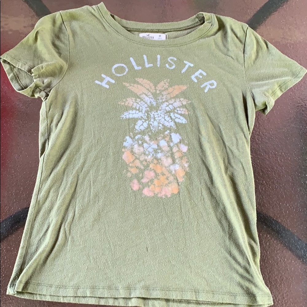 green hollister shirt with a pineapple on it.